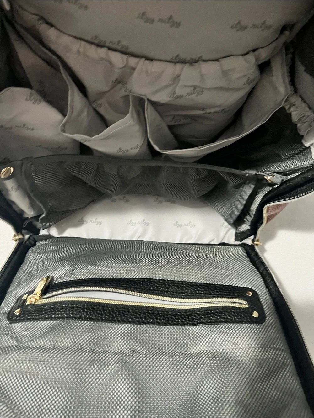 Itzy Ritzy Baby Diaper Bag Backpack in Black, White, brown with wipes case
